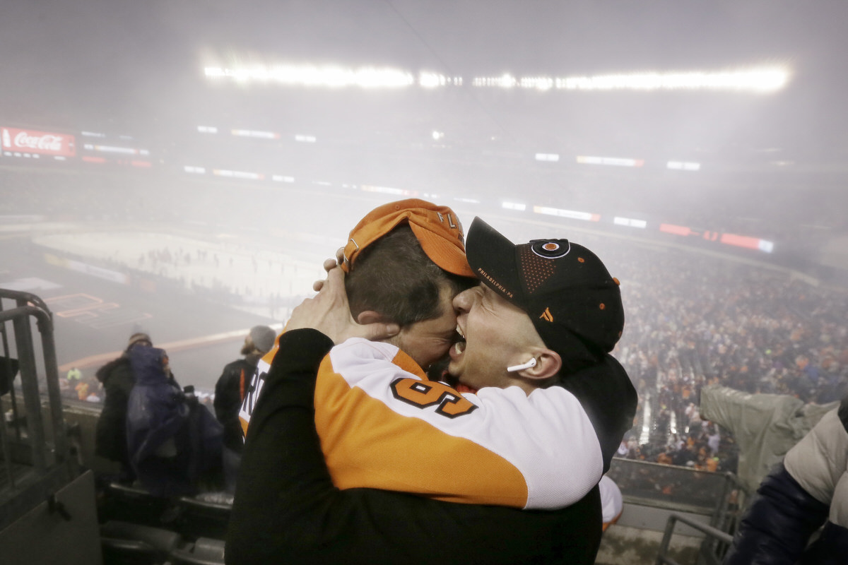 Dmitriy Krepkikh (left) and Nikita Ozherelyev, both from Philadelphia, celebrate after the Flyers won the 2019 NHL Stadium Series game against the Pittsburgh Penguins on Feb. 23 at Lincoln Financial Field.