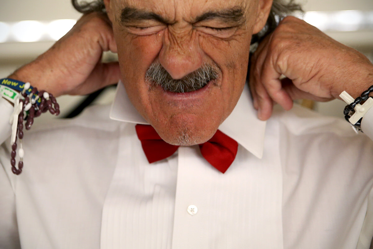 Contestant Tom Troncone of Pennsauken adjusts his collar while changing into formal wear at the sixth annual Mr. Mature America pageant in Ocean City.